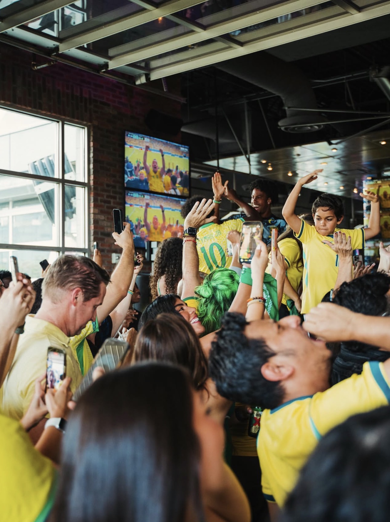 Fans packed shoulder-to-shoulder cheering under the screens at Concrete Cowboy Frisco
